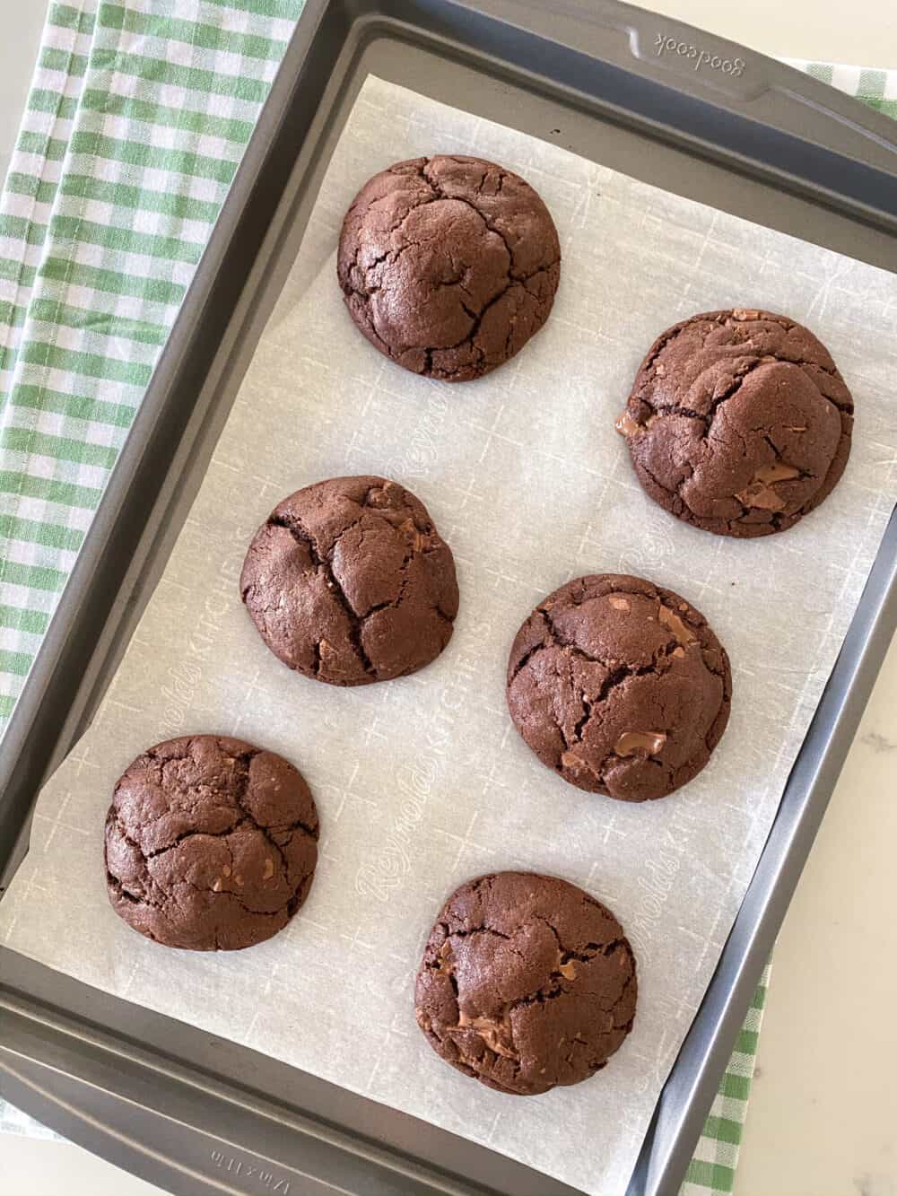 baked double chocolate chip cookies on baking sheet