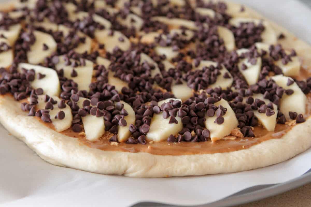 chocolate chips layered over dessert pizza dough