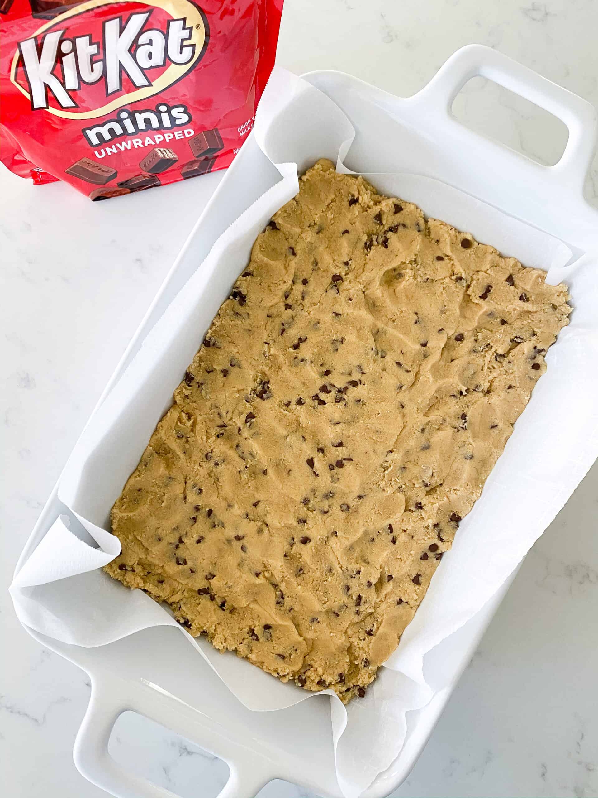 pressed cookie dough in baking dish