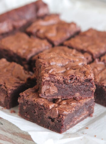 Fudge brownies cut in squares on parchment paper