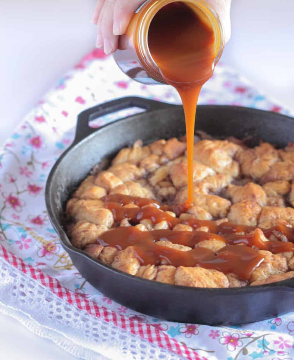 pouring caramel sauce over caramel apple pie bites