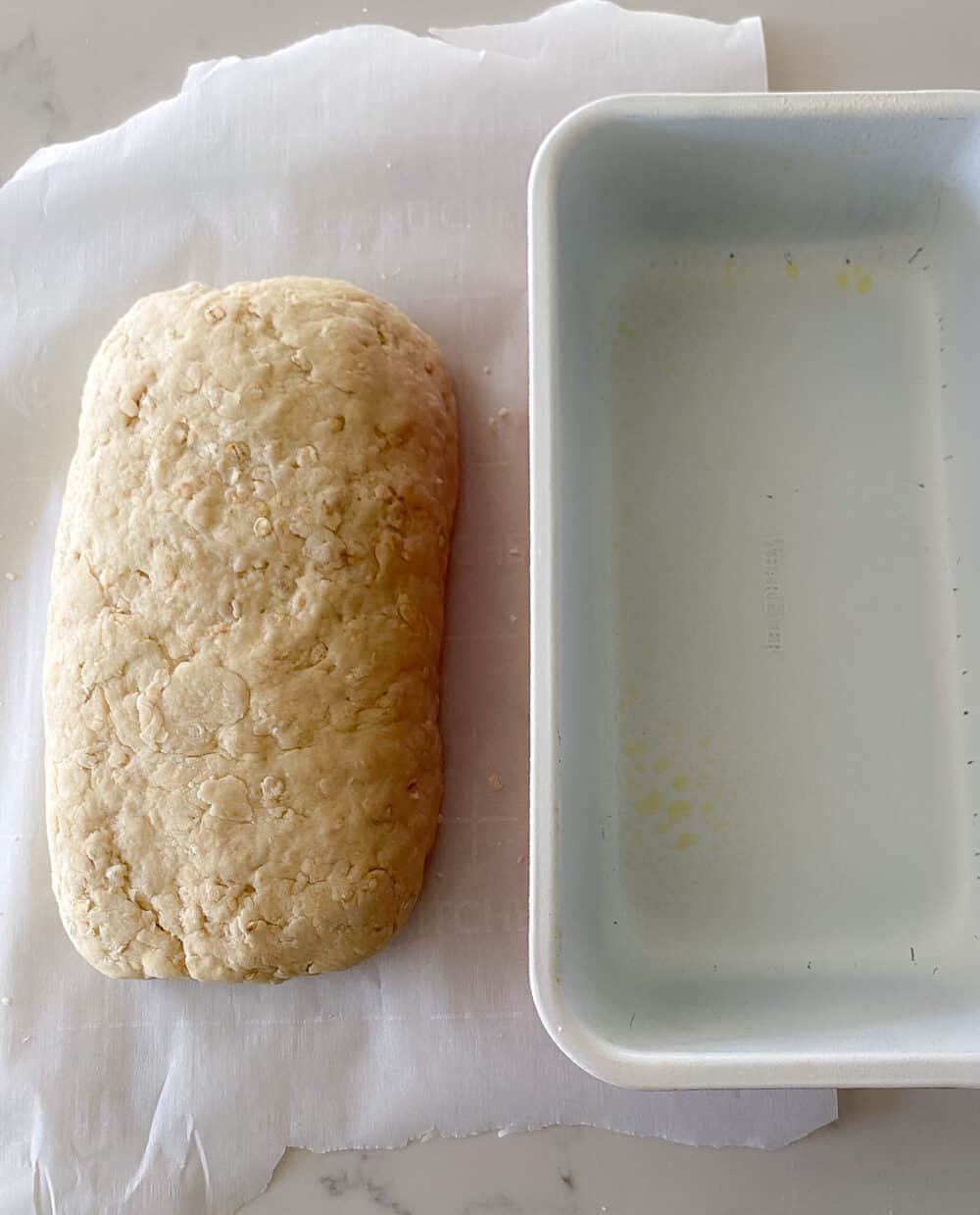 kneading bread dough on parchment paper