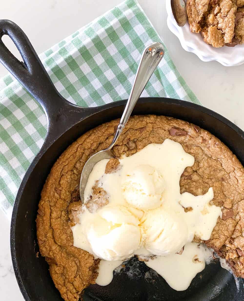 baked skillet cookie with vanilla ice cream on top