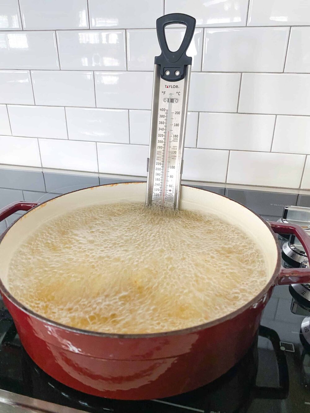 adding fries to pot of oil for pommes frites