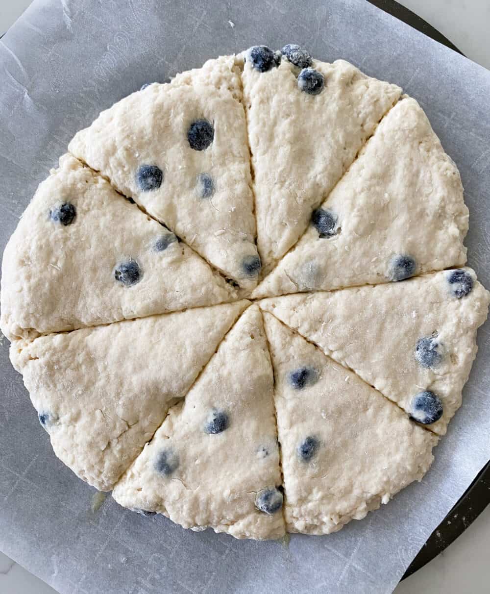 cut blueberry scones dough into wedges