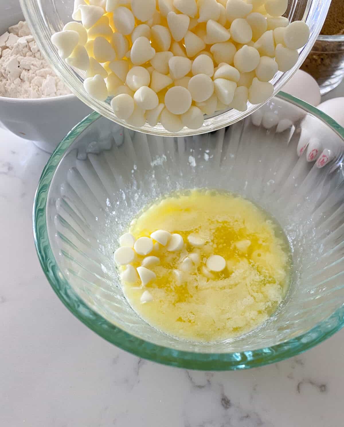 adding white chips to melted butter