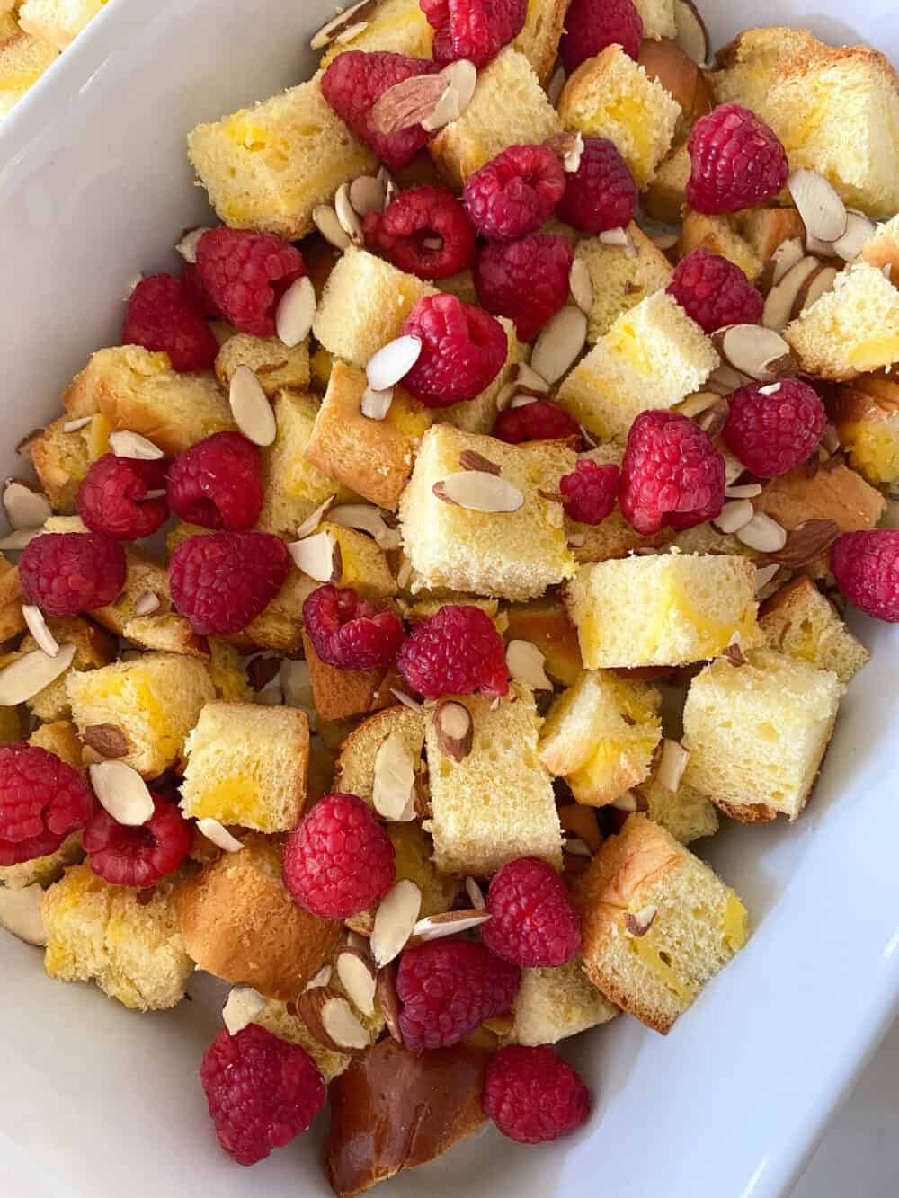 add raspberries and almonds to baking dish