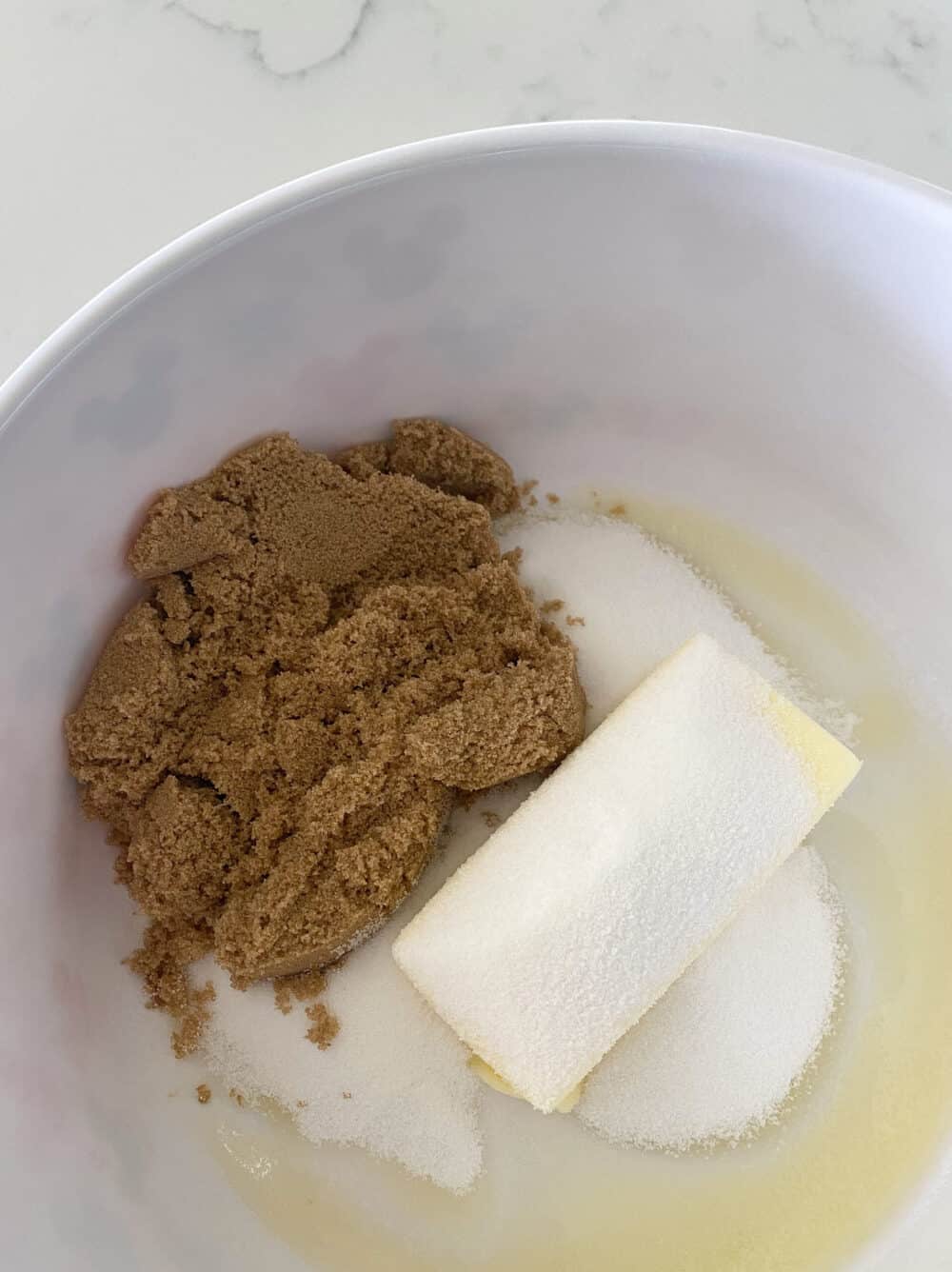 cream butter and sugars in bowl