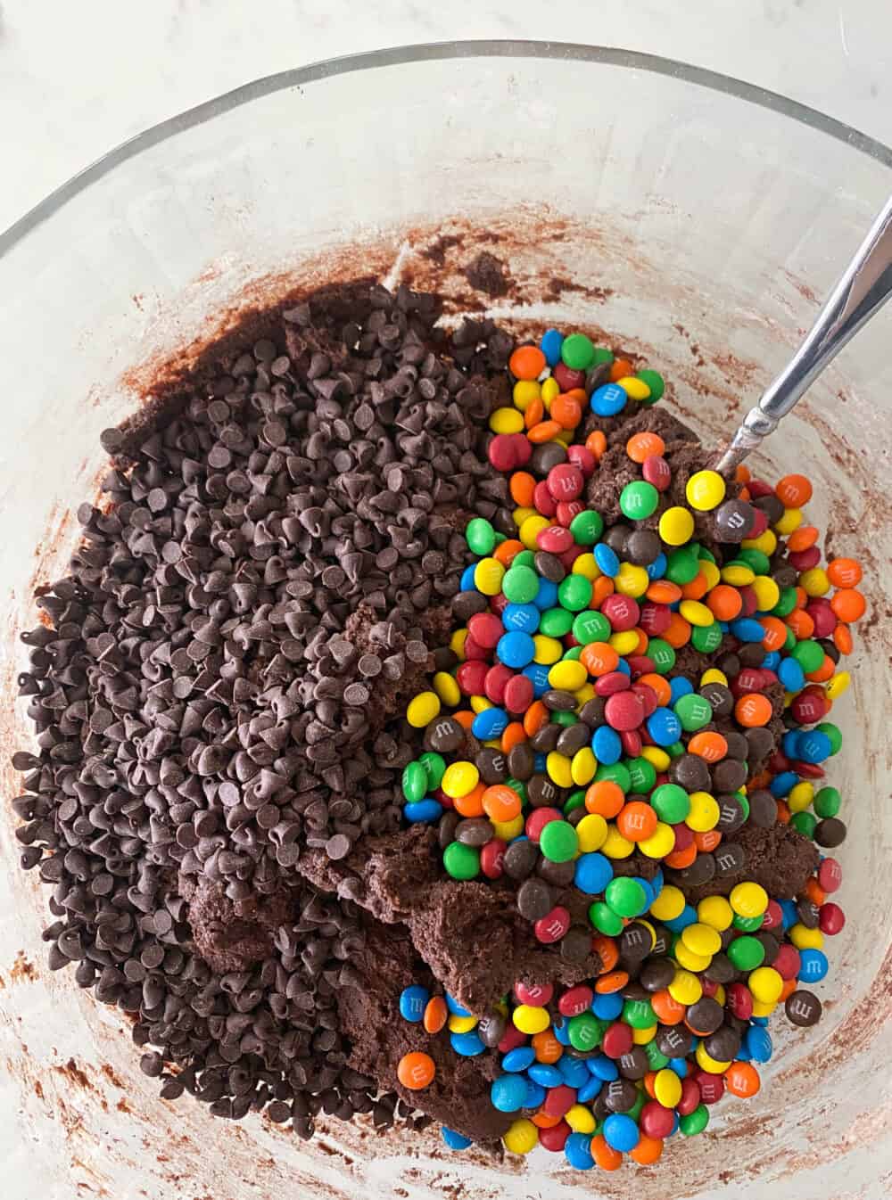 adding chocolate chips to mixing bowl