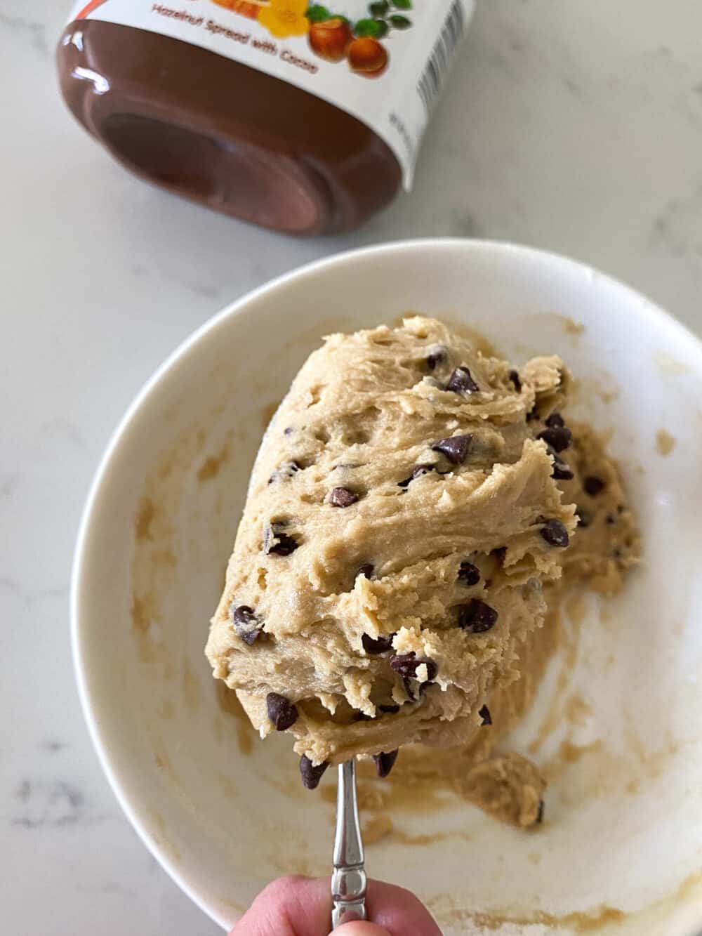 cookie dough in bowl on spoon