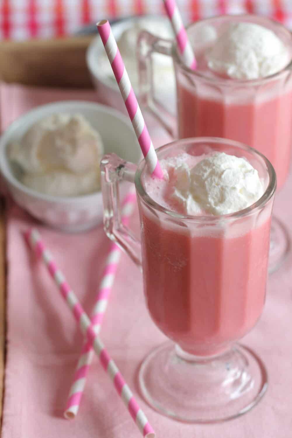 frozen strawberry milk in glass with straw