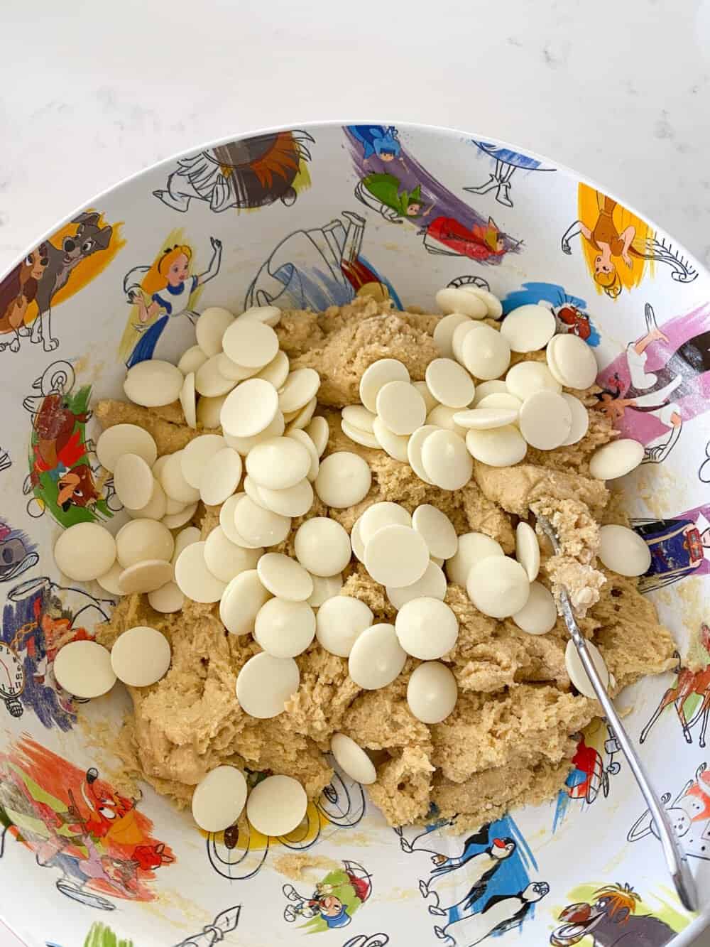 white chocolate chips in bowl of cookie dough