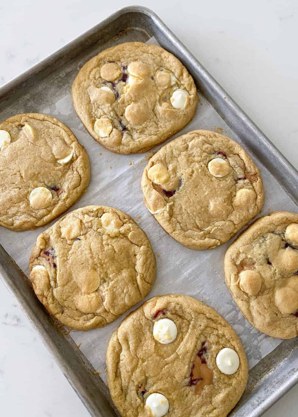 peanut butter and jelly stuffed cookies on baking sheet