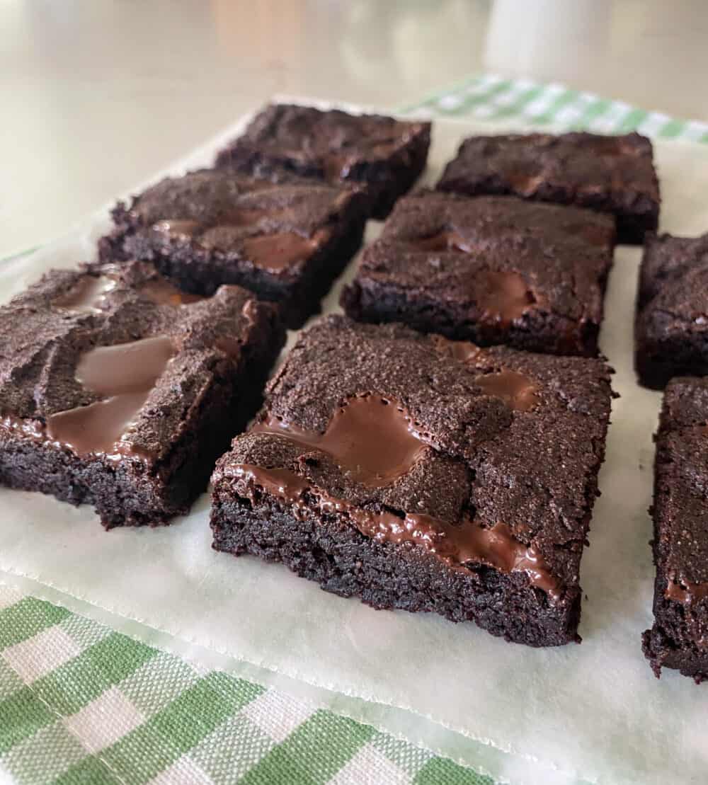 keto brownies cut in squares on parchment paper