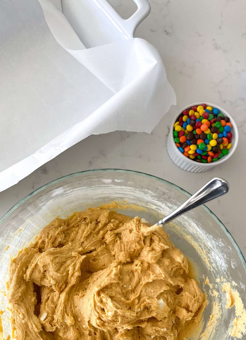 m&m cookie dough ready to transfer to baking dish