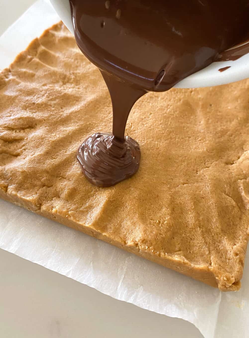 melted chocolate over peanut butter bars