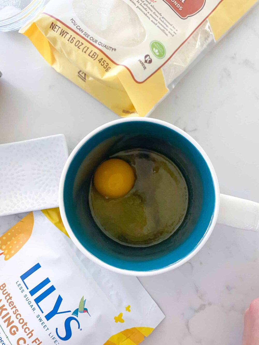 egg yolk added to mug with wet ingredients