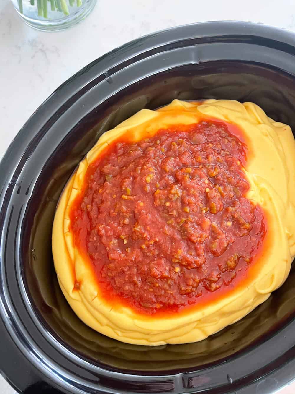 salsa and cheese in crockpot for queso recipe