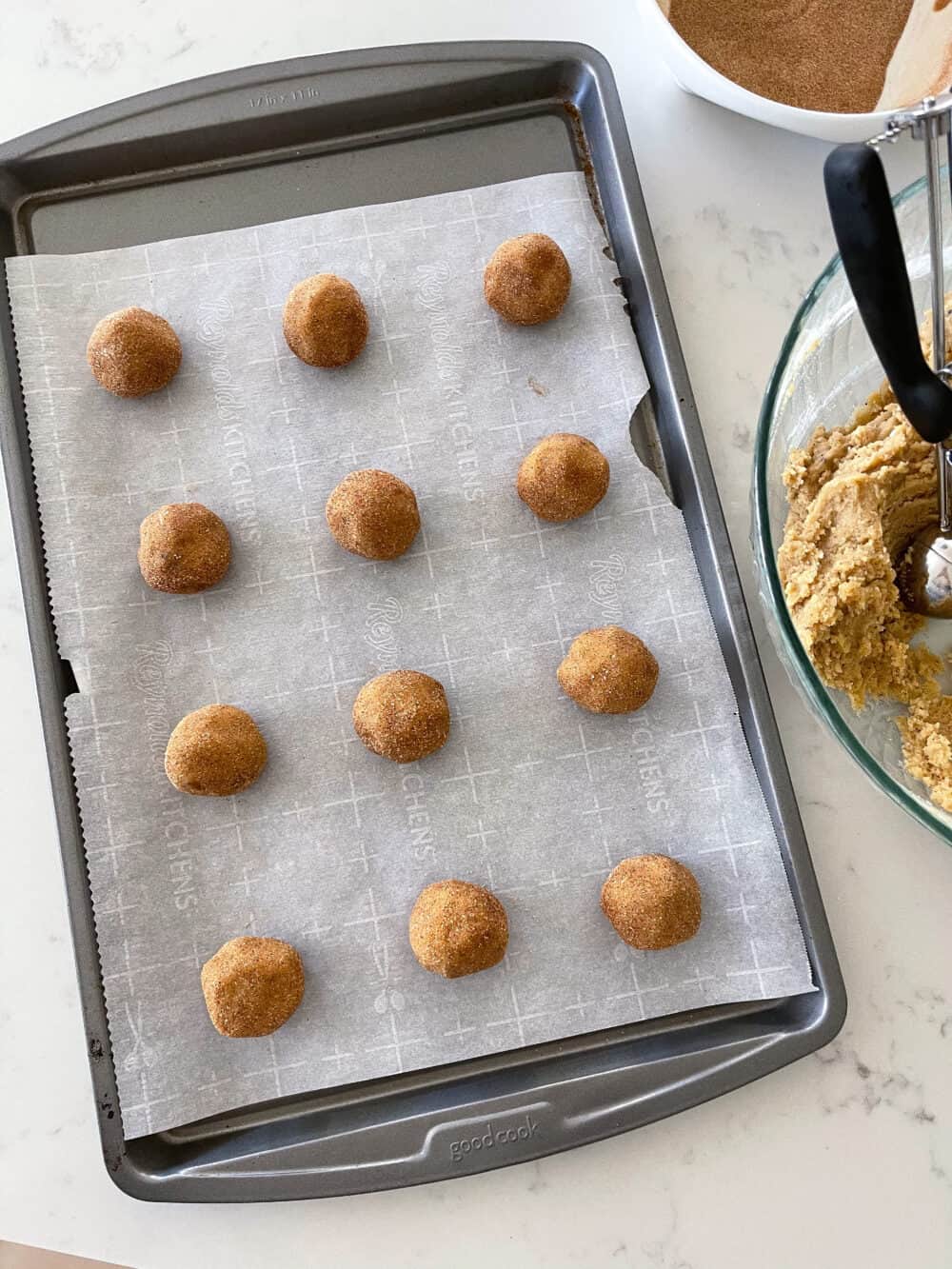 snickerdoodle cookie dough balls on baking sheet 
