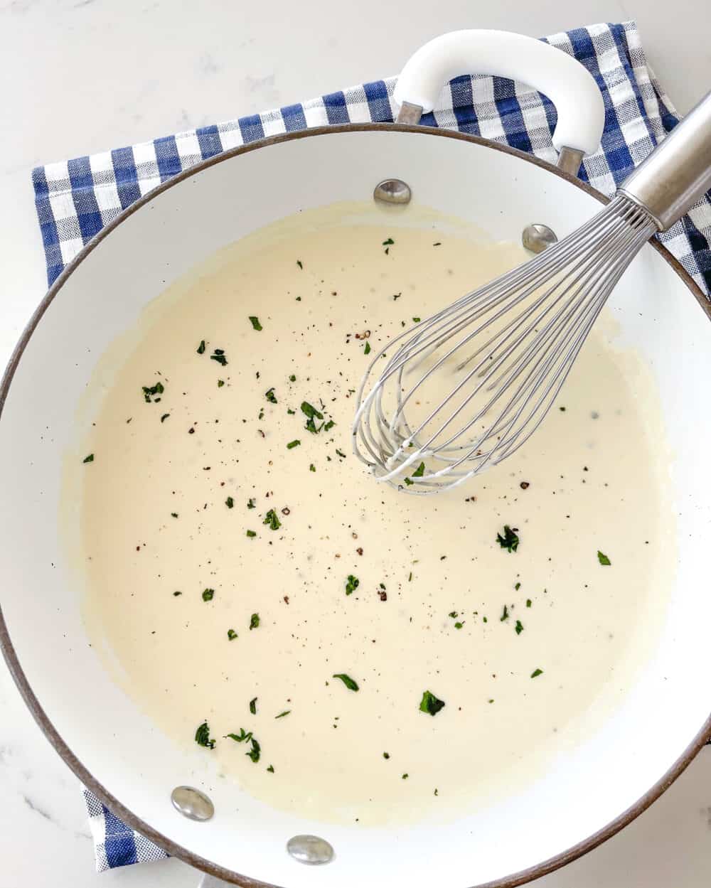 prepared homemade alfredo sauce in a dutch oven