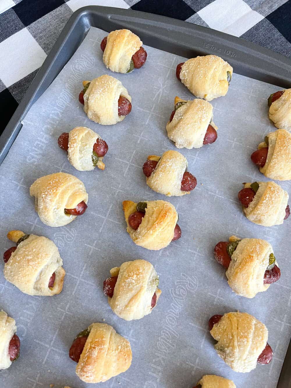 baked pigs in a blanket on baking sheet