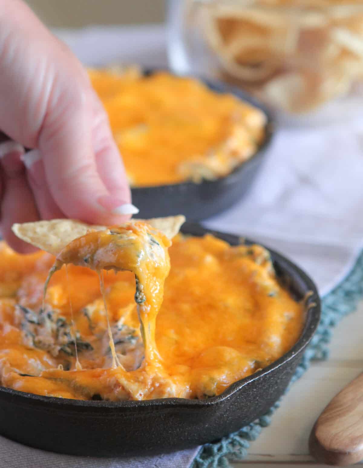 dipping chip in spinach dip