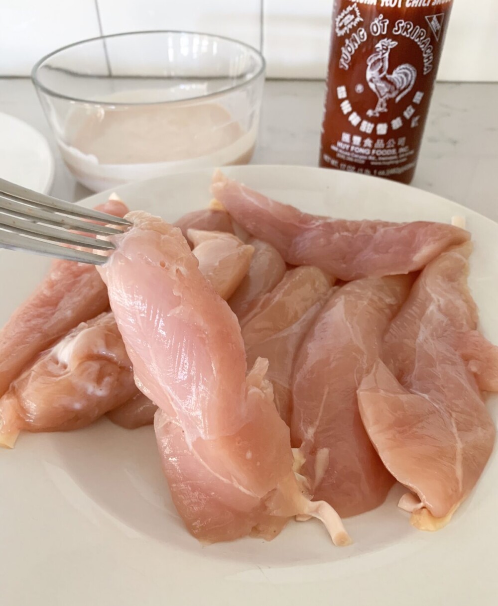 raw chicken tenders on plate ready to dip into wet ingredients