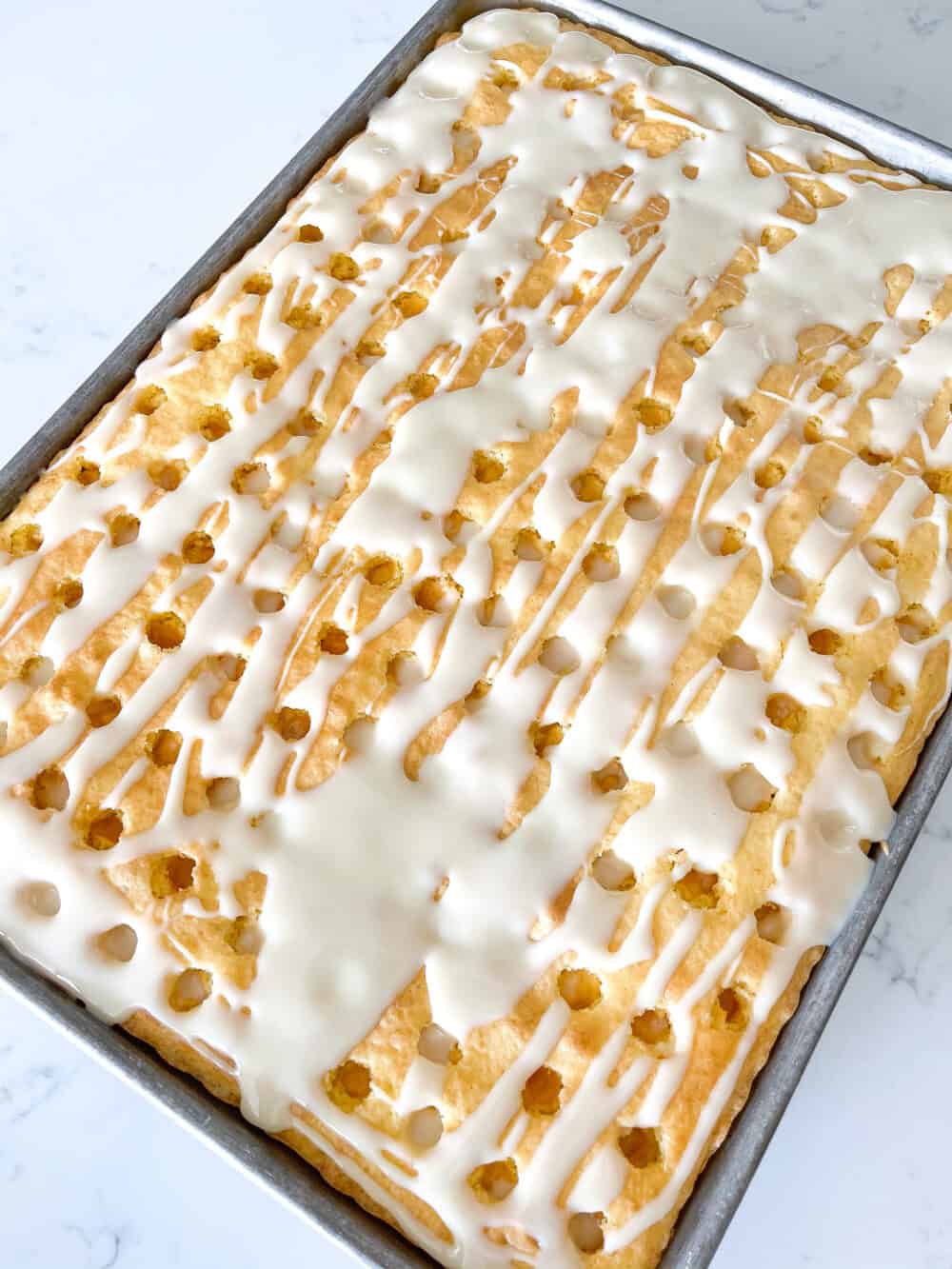 sweetened condensed milk drizzled over sheet cake
