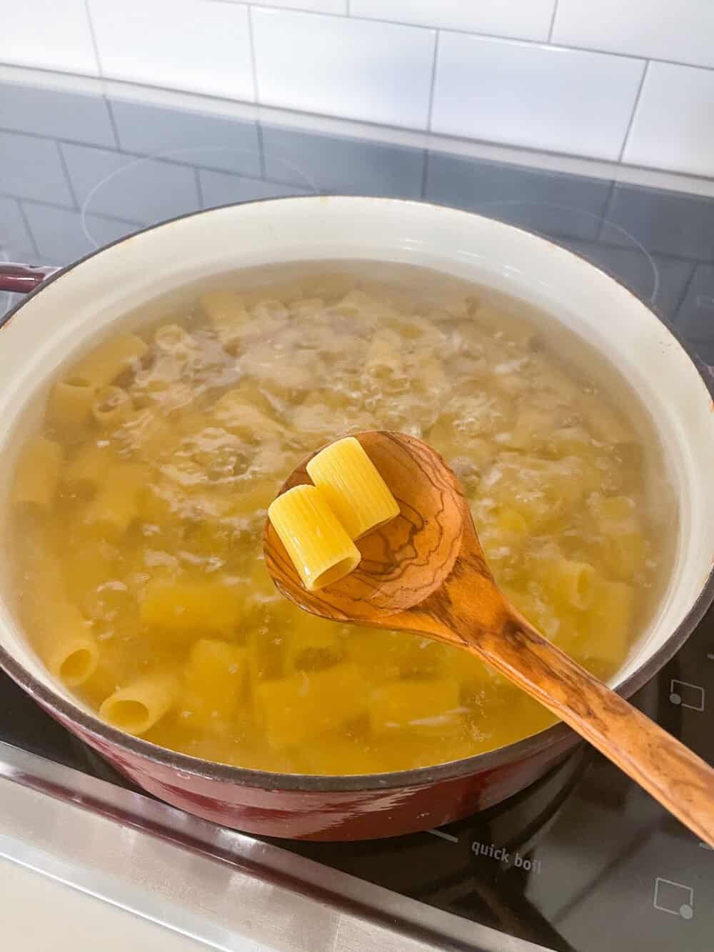 cooking rigatoni in a pot of water