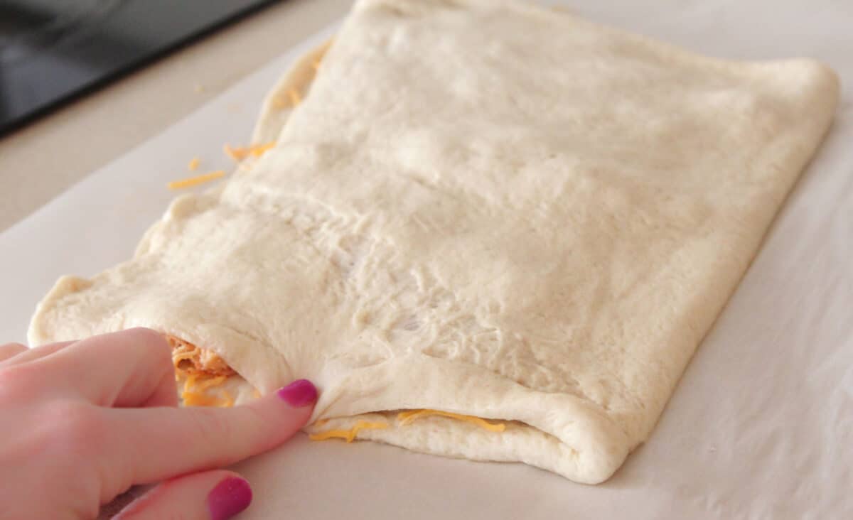 folding dough over breadstick filling