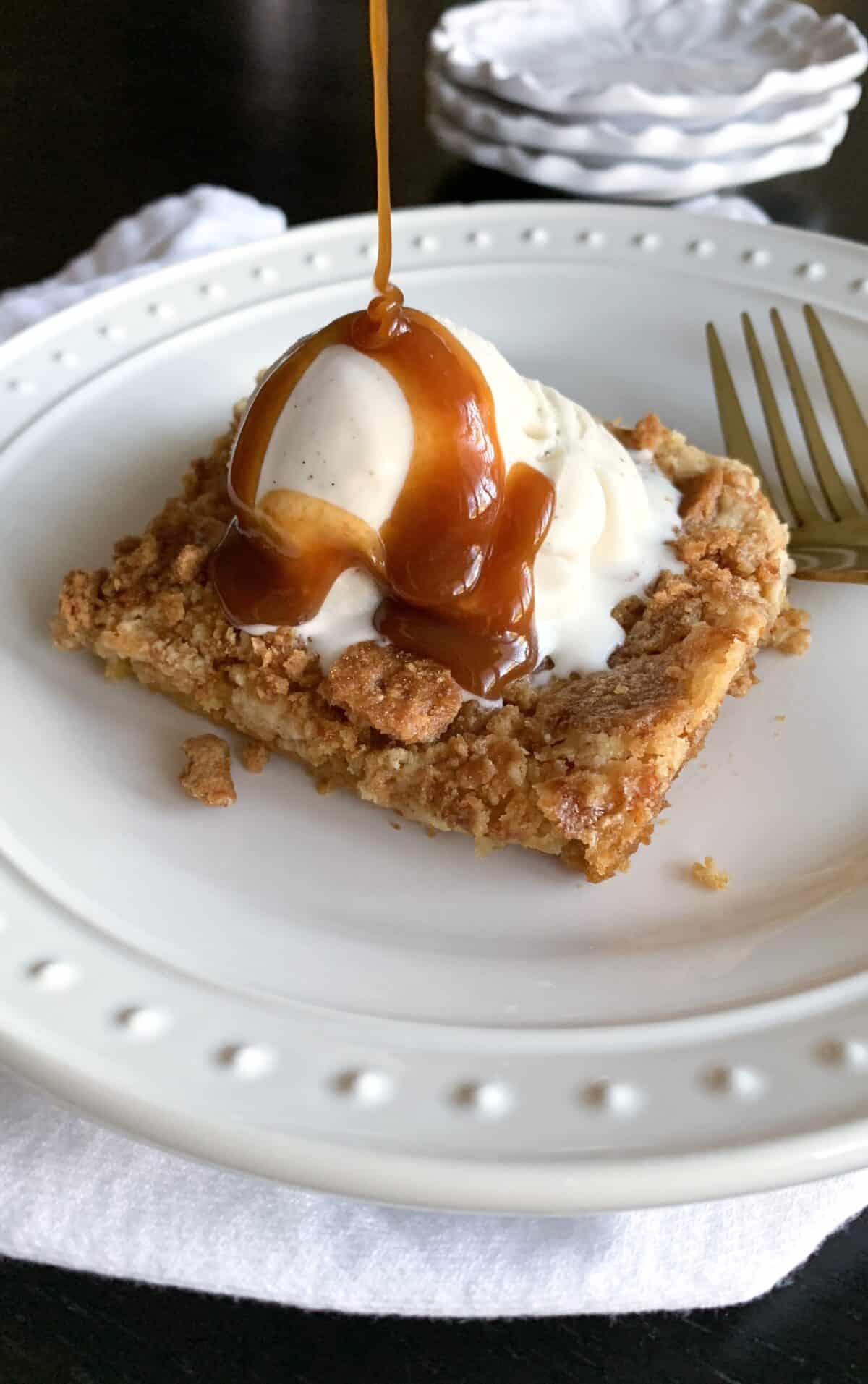 pumpkin bars with ice cream and caramel on serving plate
