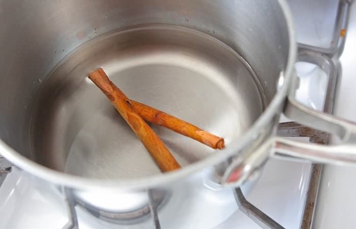 cinnamon sticks added to pot of water