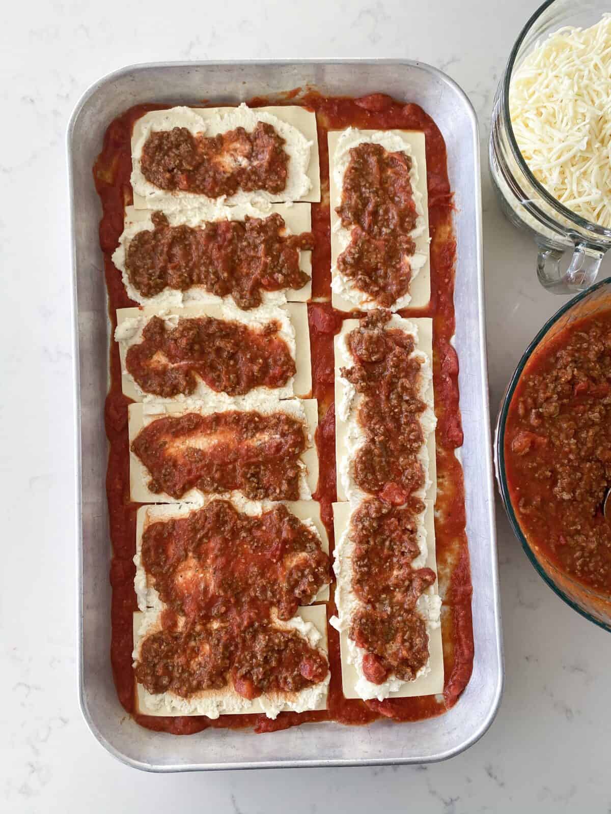 meat sauce layered over lasagna noodles