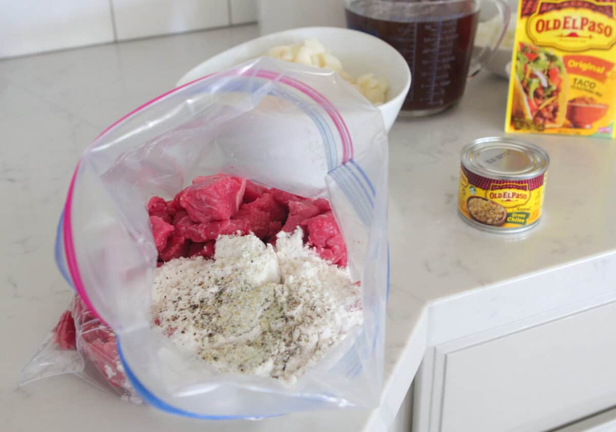 beef stew meat in ziplock with flour added