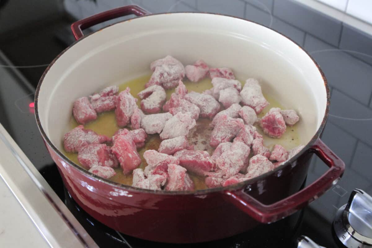 beef stew meat cooking in pot