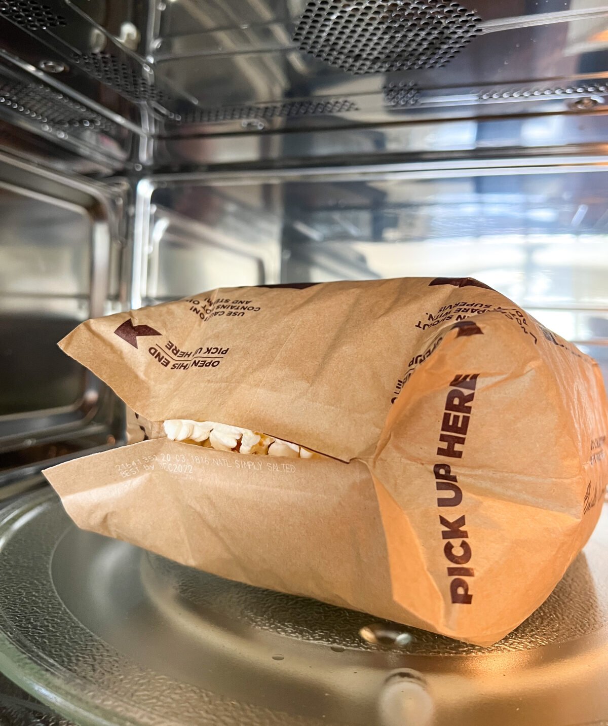 bag of popped popcorn in microwave