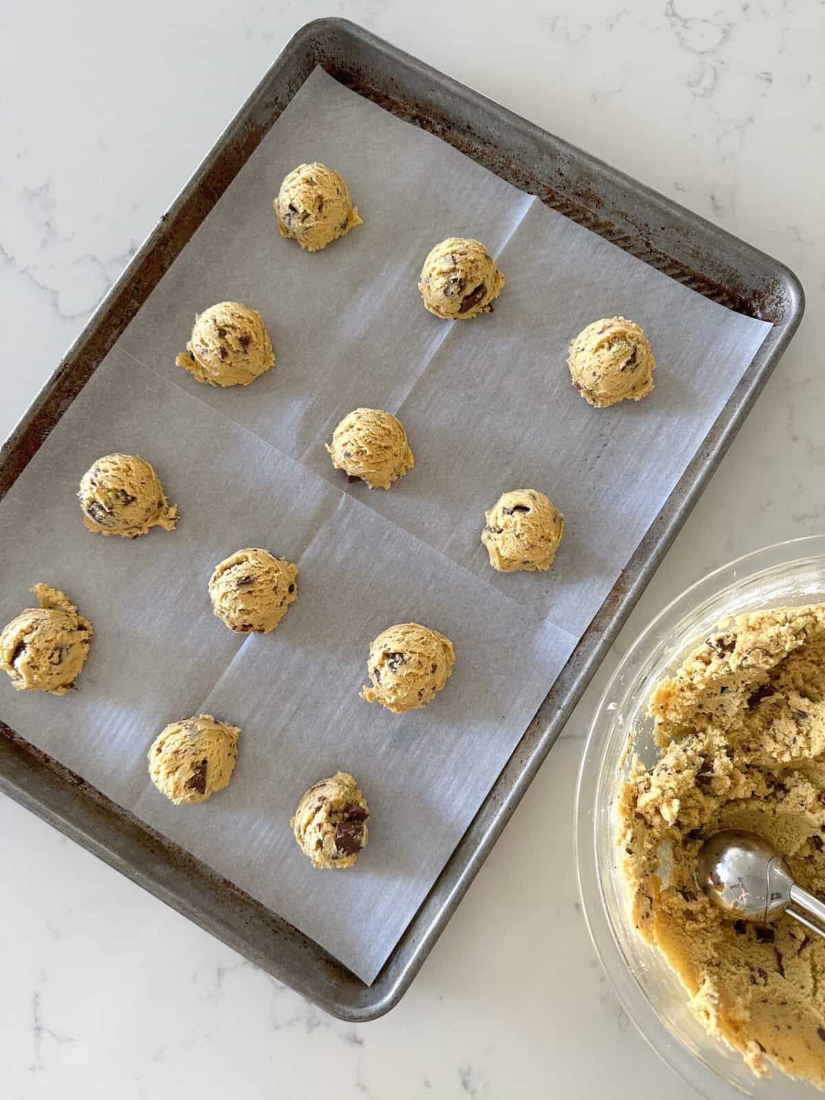 chewy chocolate chip cookie dough on baking sheet ready to bake
