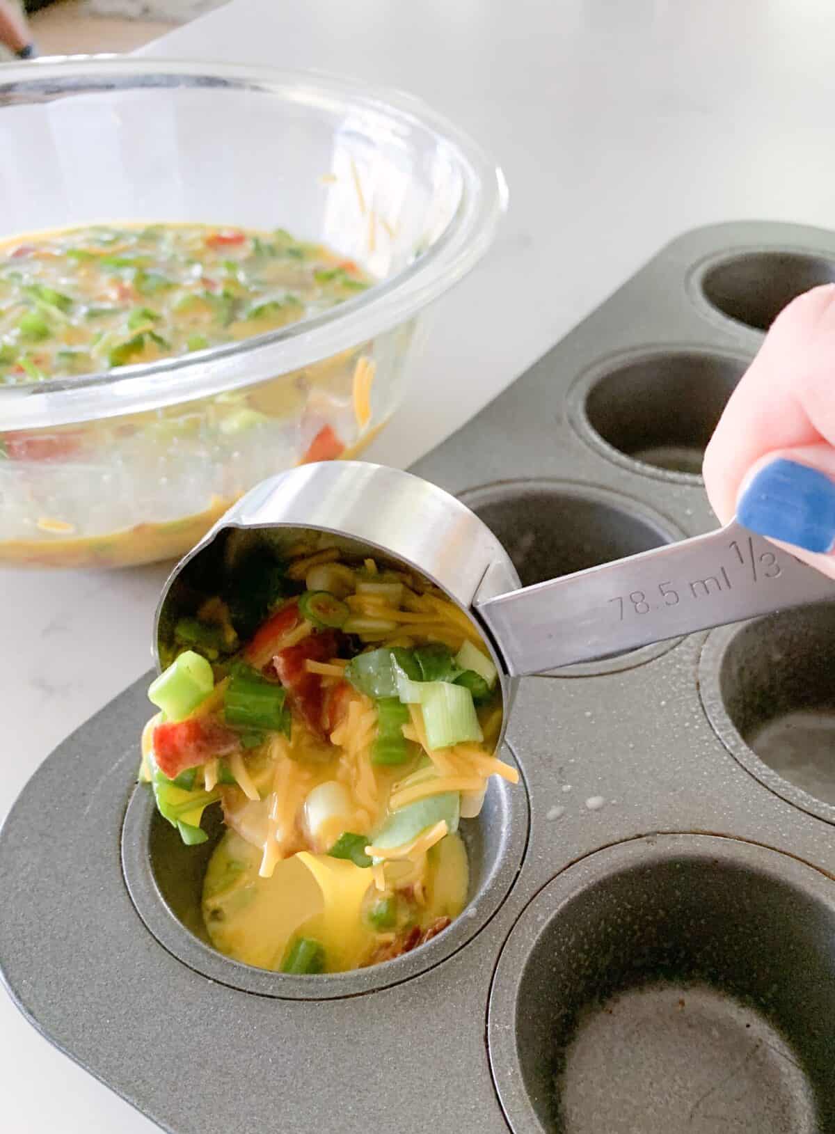 pouring egg bites mixture into muffin tins