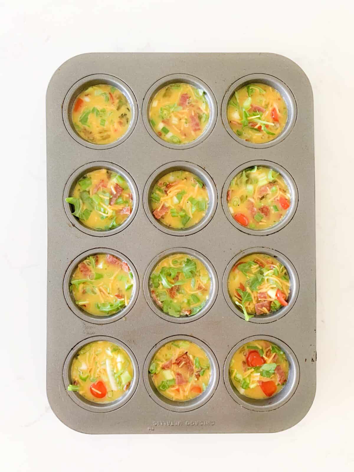 egg bites mixture in muffin tins before baking