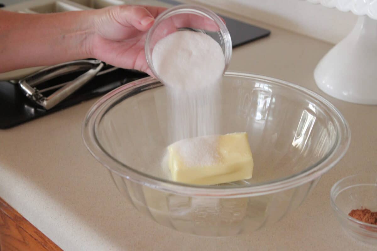 pouring sugar in mixing bowl with butter