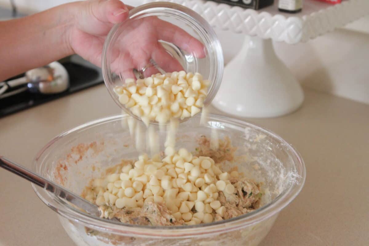 pouring white chips in mixing bowl