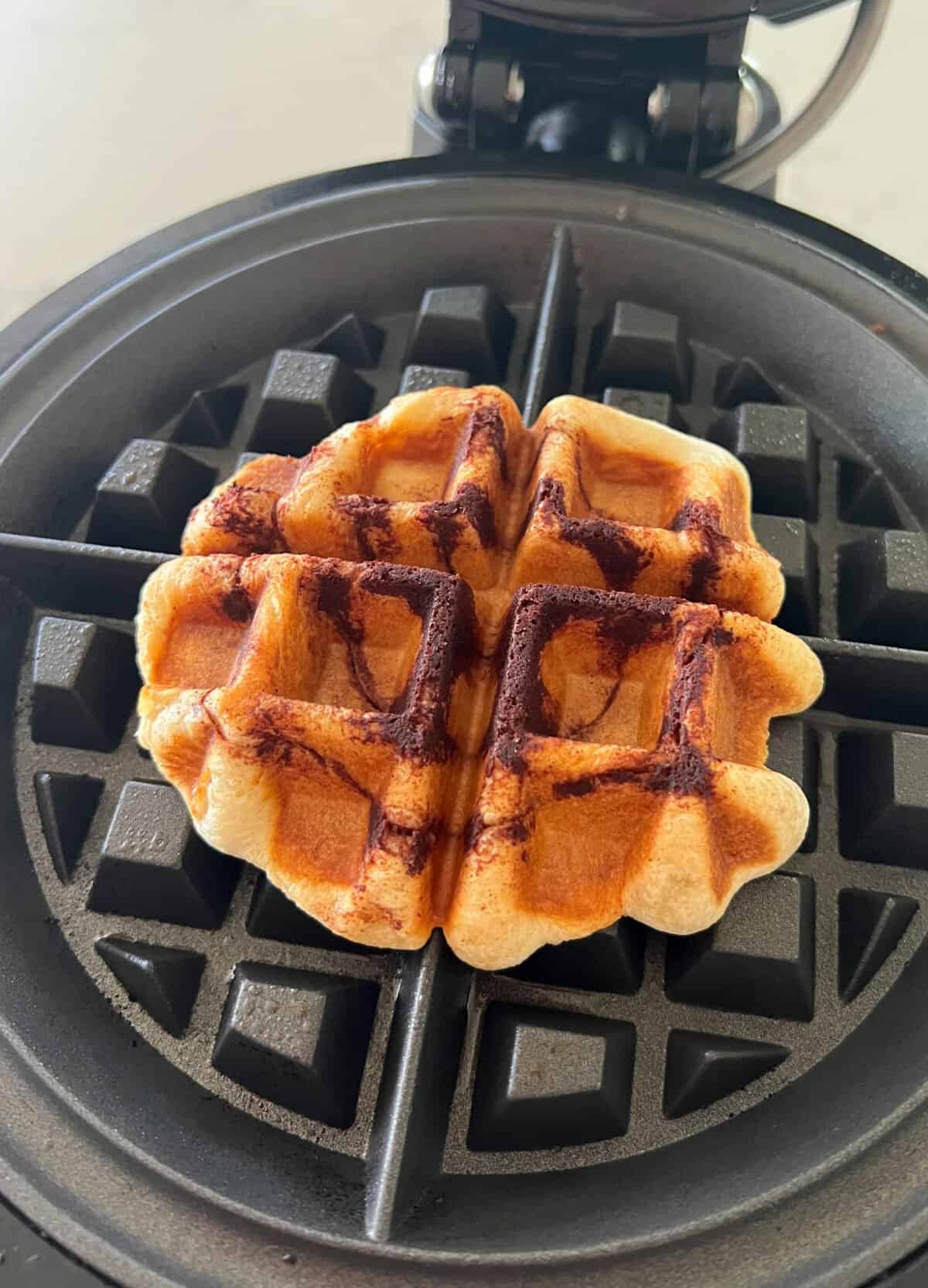 cooked cinnamon roll in waffle maker