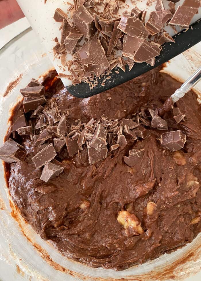 adding chocolate chunks to mixing bowl