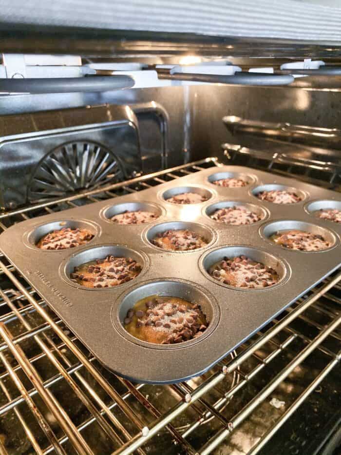 pumpkin chocolate chip muffins baking in oven