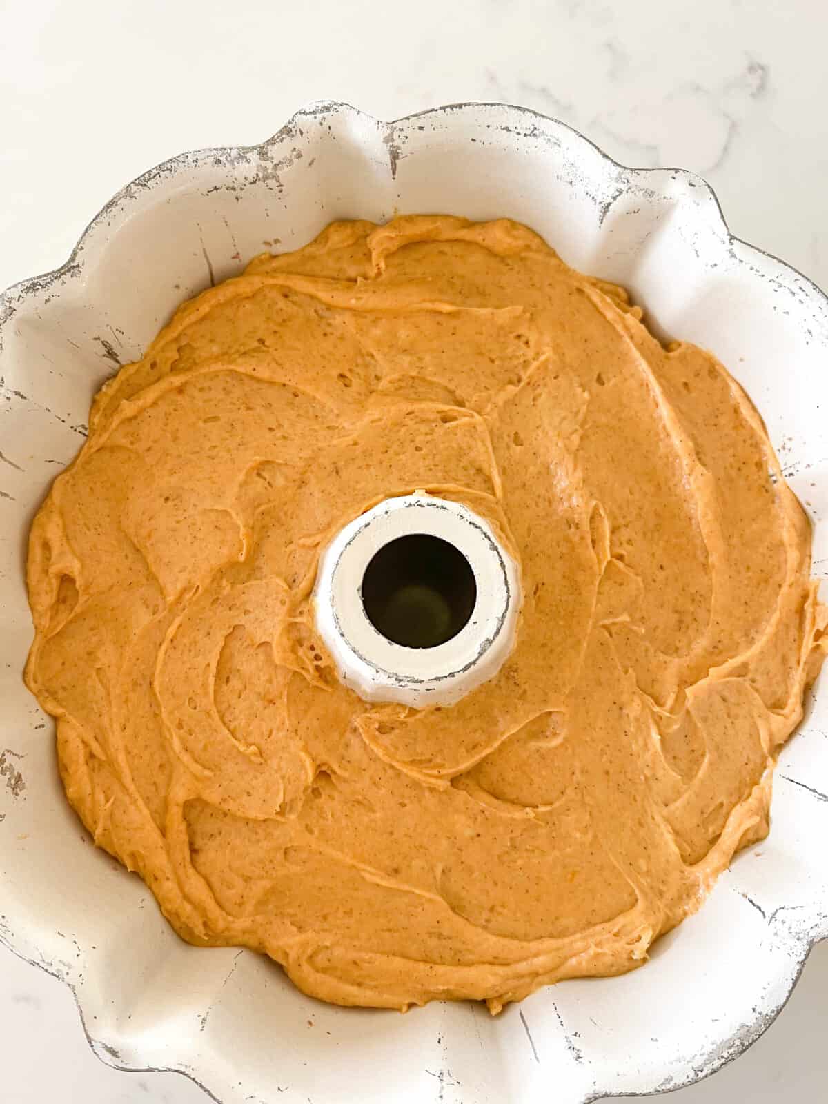 pumpkin bundt cake batter in bundt cake pan