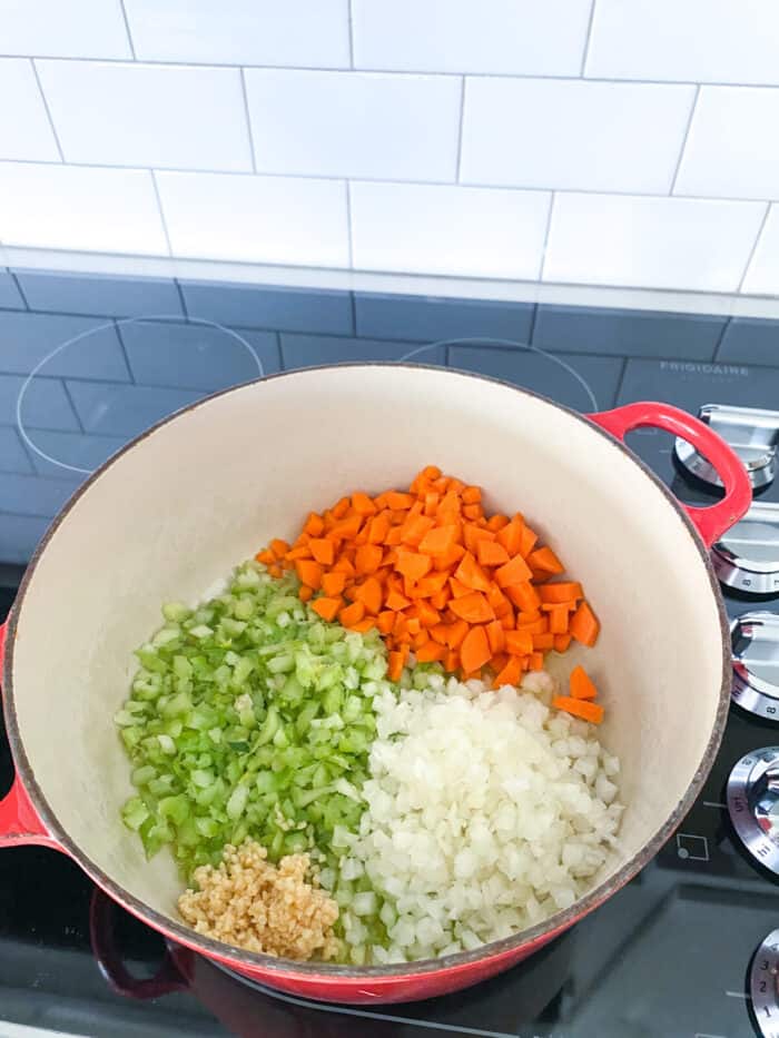 vegetables added to soup pan