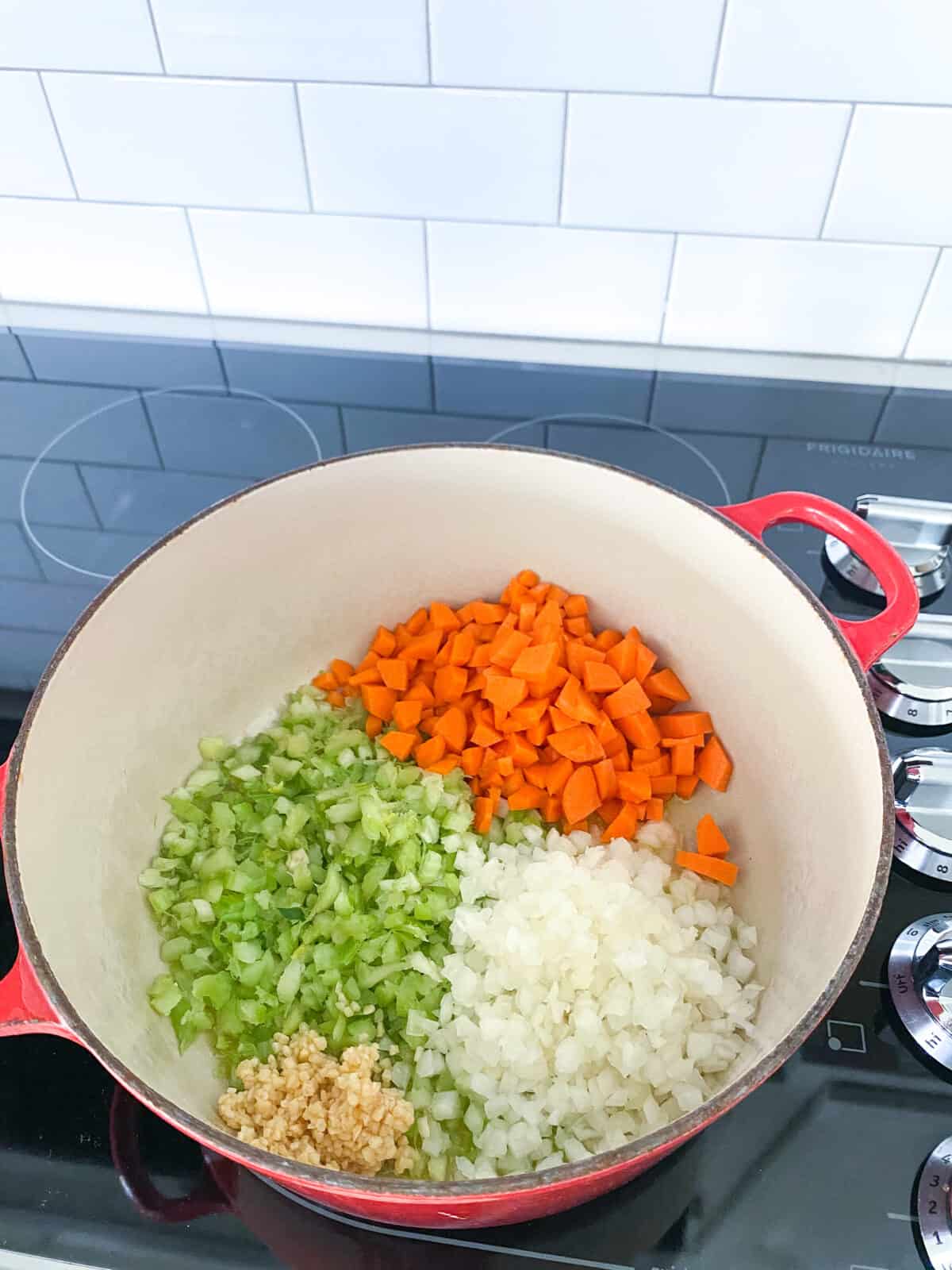 vegetables added to soup pan 