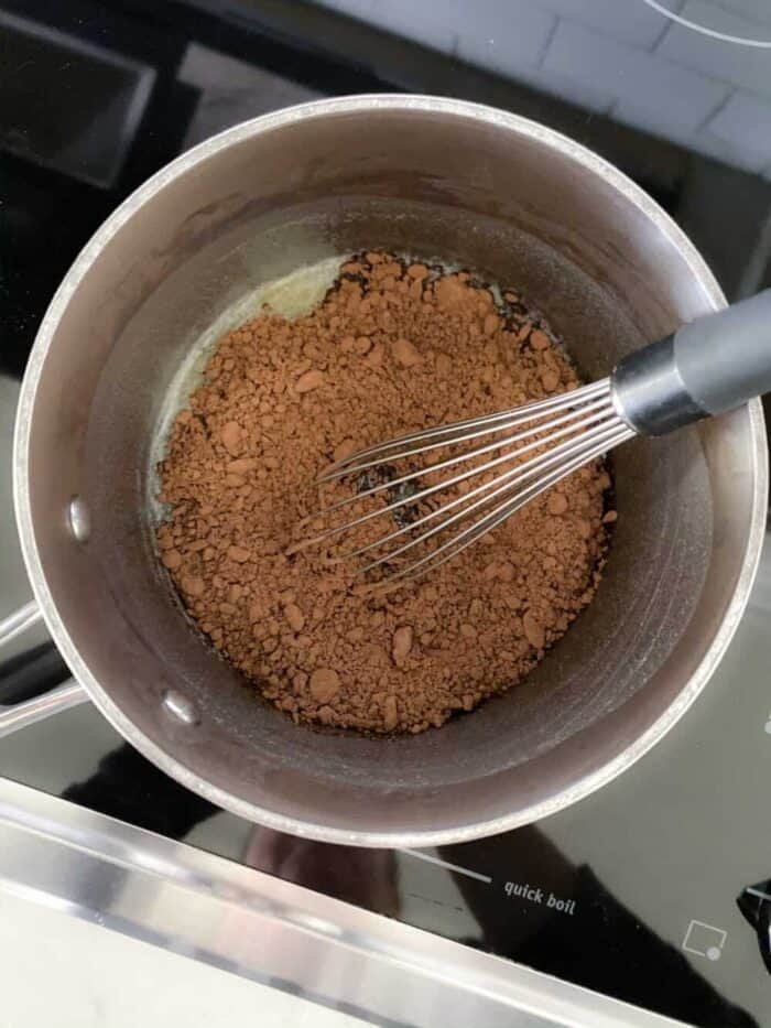 cocoa powder added to saucepan with melted butter