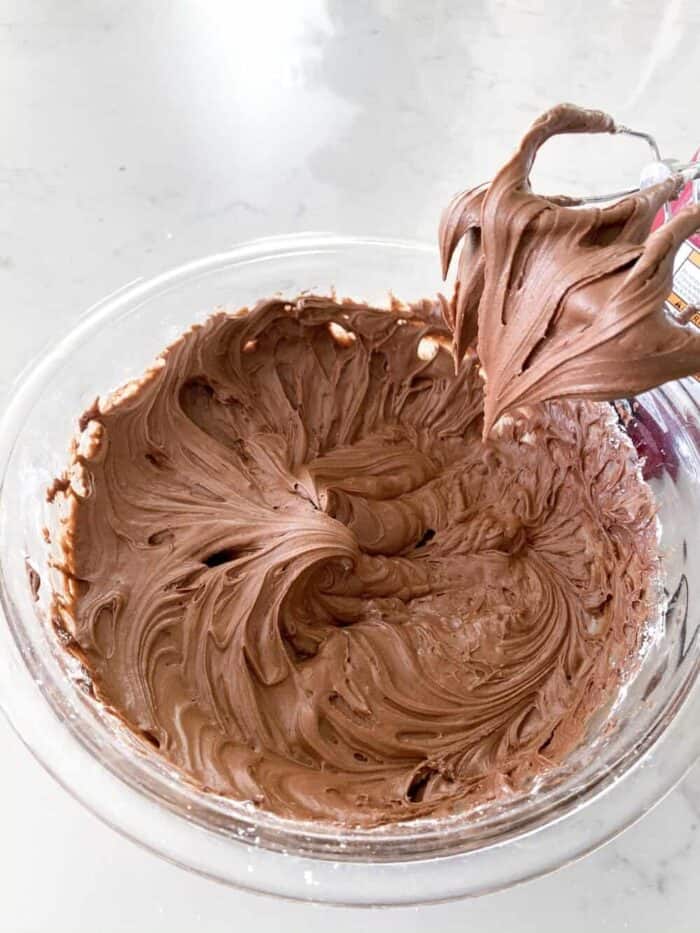 chocolate frosting in mixing bowl with beaters