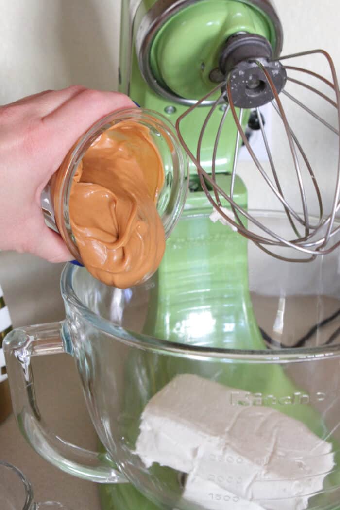 adding peanut butter to cream cheese in mixing bowl